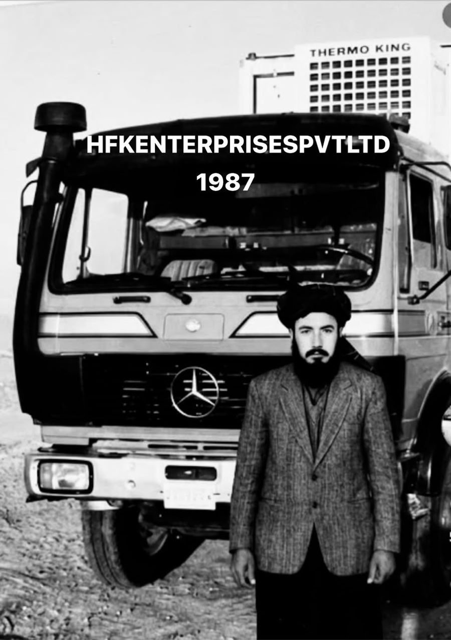 Haji Fateh Khan, founder of HFK Enterprises, standing in front of his Mercedes-Benz truck with a Thermo King refrigeration unit in 1987