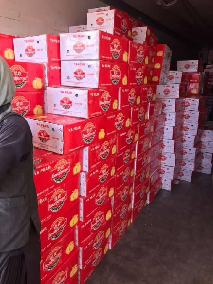 Stacks of boxed pears in a warehouse ready for loading